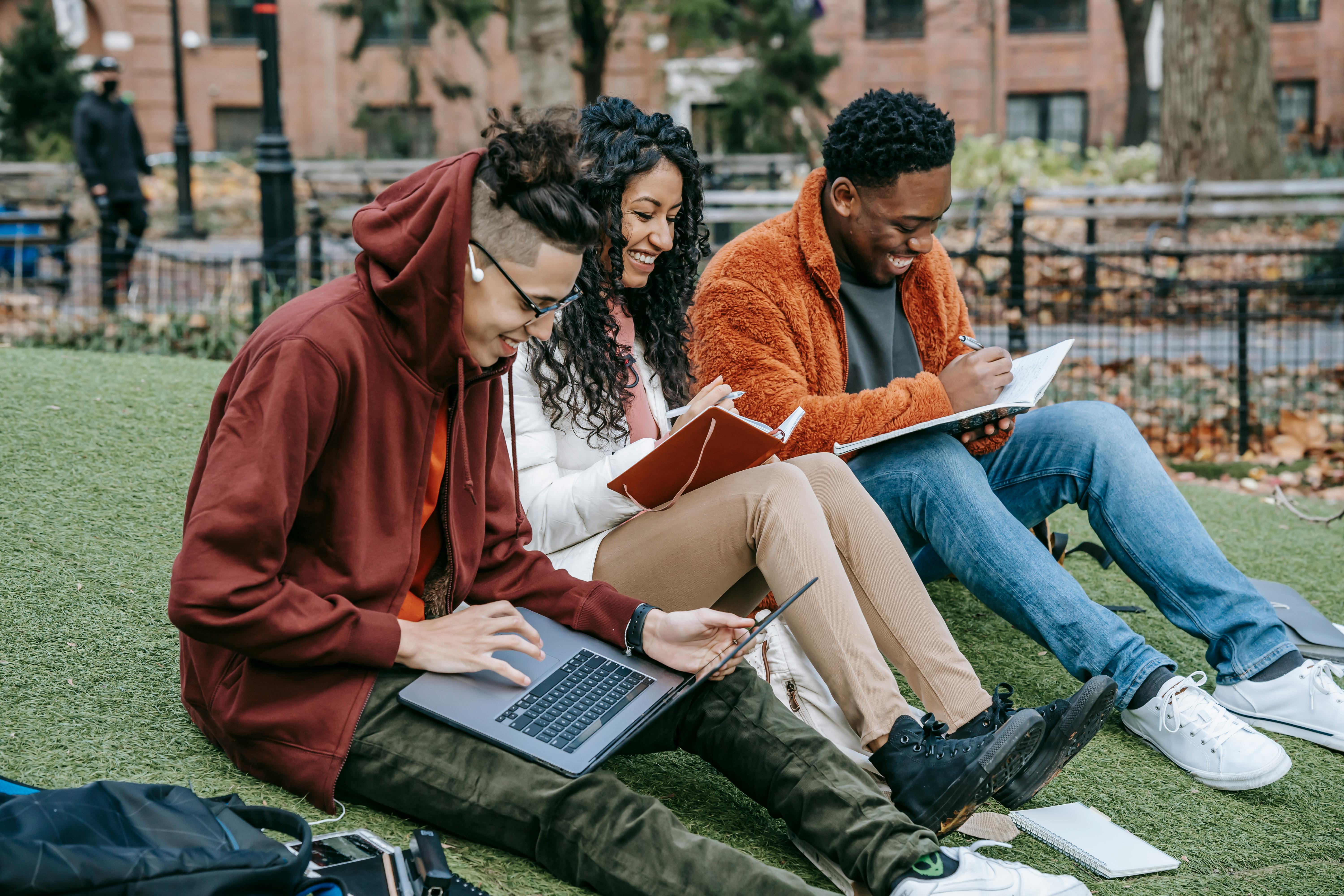 Students reading on a lawn